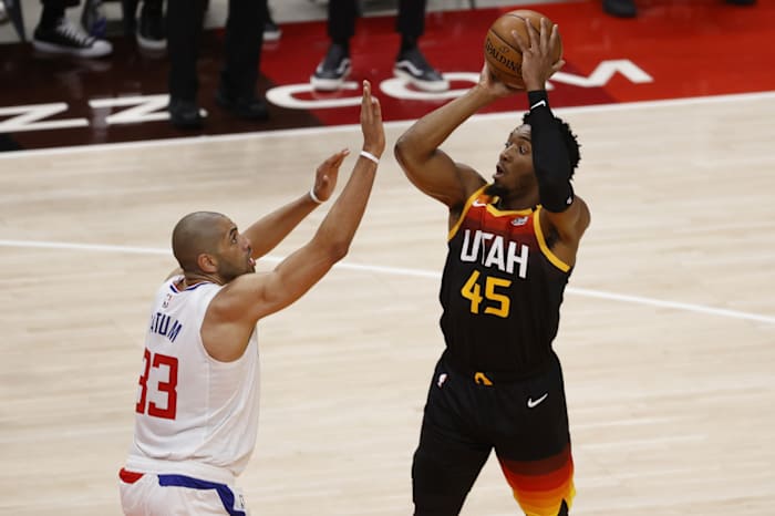 Donovan Mitchell (45) scores over Nicolas Batum (33) 